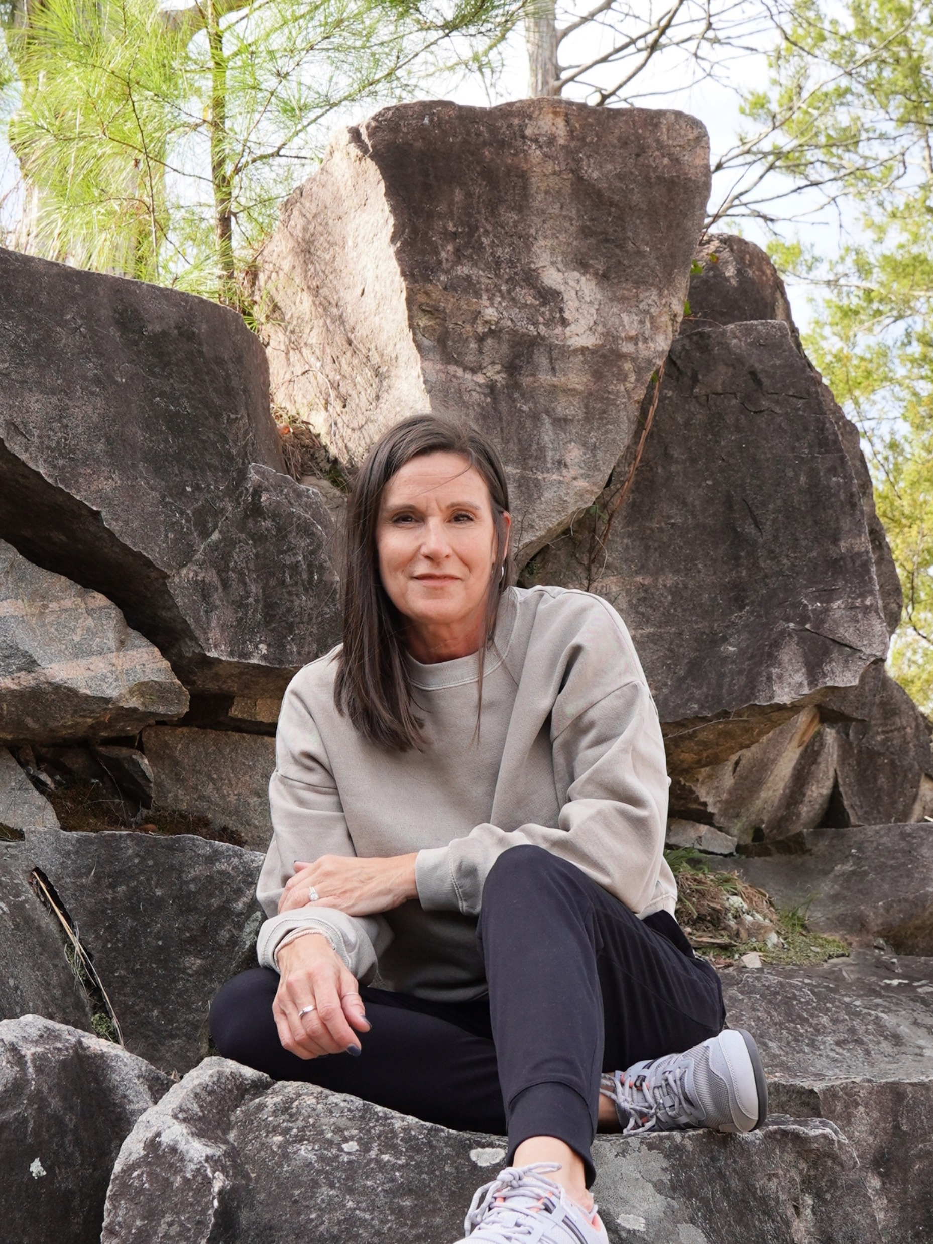 Picture of author sitting on rock formation